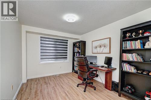 Bright interior space featuring wood-finish flooring, a large window with horizontal blinds, and recessed lighting - 519 Yorkshire Drive, Waterloo, ON - Indoor Photo Showing Office