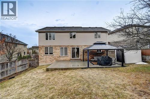 Rear exterior featuring a ground-level patio, brick and siding facade, and a private backyard - 519 Yorkshire Drive, Waterloo, ON - Outdoor