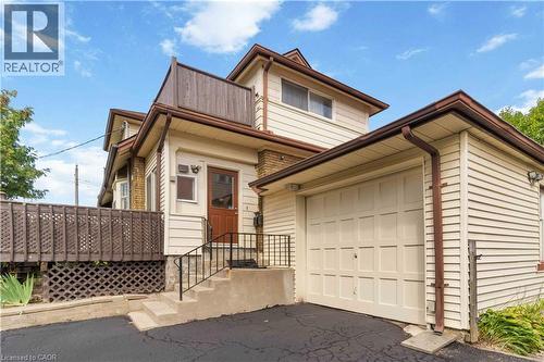 Cream-colored siding exterior with brown trim and gutters - 151 Louisa Street, Kitchener, ON - Outdoor