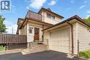 Cream-colored siding exterior with brown trim and gutters - 151 Louisa Street, Kitchener, ON  - Outdoor 