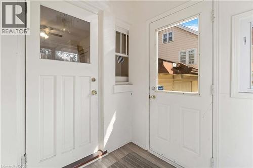 Two white paneled doors with upper glass inserts - 151 Louisa Street, Kitchener, ON - Indoor Photo Showing Other Room