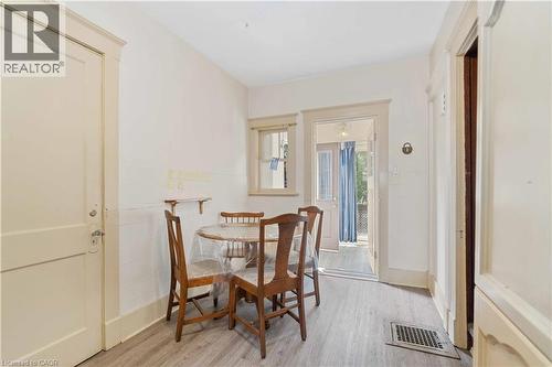 Interior space featuring wood-finish flooring, white walls, and a recessed window - 151 Louisa Street, Kitchener, ON - Indoor Photo Showing Dining Room