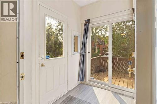 Sliding glass patio doors opening to an outdoor deck with lattice railing - 151 Louisa Street, Kitchener, ON - Indoor Photo Showing Other Room