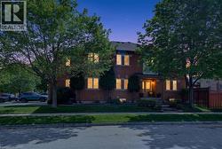 Two-story brick facade residence with a welcoming covered front porch - 