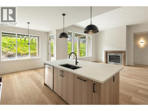 2125 Montenegro Drive, Kelowna, BC - Indoor Photo Showing Kitchen With Fireplace With Double Sink