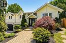 Split-level residence featuring light yellow siding with white trim accents and gabled rooflines - 2207 Jester Court, Burlington, ON  - Outdoor 