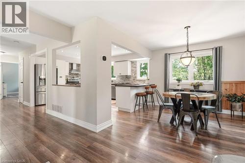 Warm wood-finish flooring extending through the dining area and kitchen - 2207 Jester Court, Burlington, ON - Indoor Photo Showing Dining Room