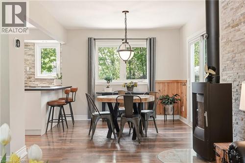 Open concept dining area featuring wood-finish flooring and a contemporary pendant light fixture - 2207 Jester Court, Burlington, ON - Indoor Photo Showing Dining Room