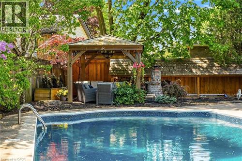 In-ground swimming pool featuring a patterned liner and concrete coping - 2207 Jester Court, Burlington, ON - Outdoor With In Ground Pool