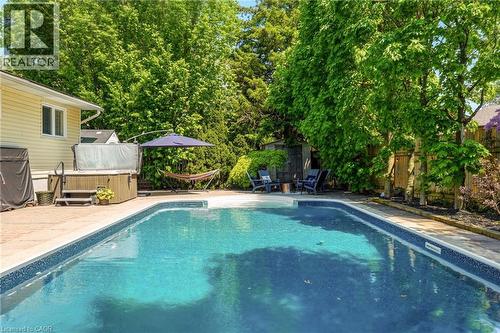 In-ground swimming pool with a concrete surround - 2207 Jester Court, Burlington, ON - Outdoor With In Ground Pool With Backyard