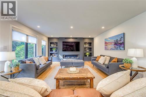 Open-concept living area featuring light wood-finish flooring, recessed lighting, and large windows - 54 Deerview Avenue, Ancaster, ON - Indoor Photo Showing Living Room
