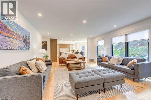 Bright interior featuring recessed lighting and large windows with privacy shades - 54 Deerview Avenue, Ancaster, ON - Indoor Photo Showing Living Room