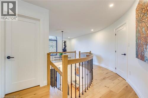 Curved hallway featuring light wood-finish flooring and recessed lighting - 54 Deerview Avenue, Ancaster, ON - Indoor Photo Showing Other Room