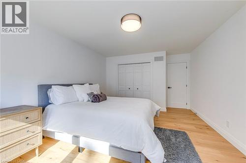 Bedroom featuring wood-finish flooring, crisp white walls, and a recessed ceiling light fixture - 54 Deerview Avenue, Ancaster, ON - Indoor Photo Showing Bedroom