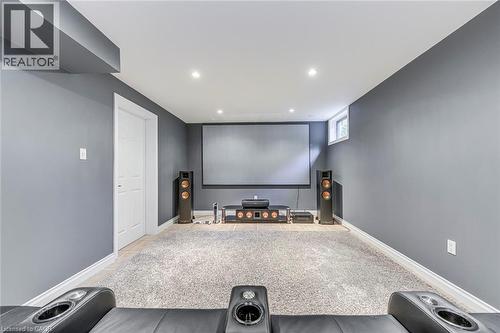 Dedicated media room featuring a large projection screen, recessed lighting, a high ceiling, and a high window - 54 Deerview Avenue, Ancaster, ON - Indoor Photo Showing Other Room