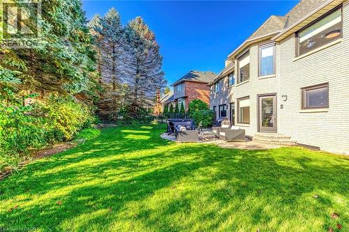 Expansive rear yard featuring a manicured lawn and mature perimeter trees - 54 Deerview Avenue, Ancaster, ON - Outdoor