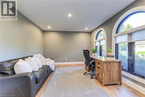 Room featuring arched windows, recessed lighting, wood-finish flooring, and neutral wall tones - 54 Deerview Avenue, Ancaster, ON - Indoor Photo Showing Office