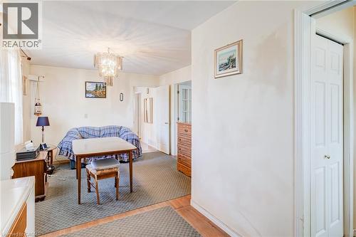 Interior space featuring a decorative chandelier, light-toned walls, and wood-finish flooring - 186 Adeline Avenue, Hamilton, ON - Indoor Photo Showing Other Room