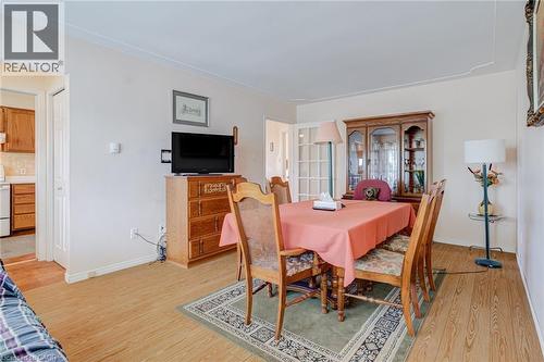 Light wood-finish flooring throughout, complemented by crown molding and baseboards - 186 Adeline Avenue, Hamilton, ON - Indoor Photo Showing Dining Room