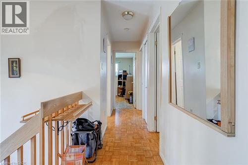 Hallway with wood-finish parquet flooring and white walls - 186 Adeline Avenue, Hamilton, ON - Indoor Photo Showing Other Room