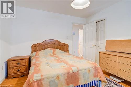 Bedroom featuring wood-finish flooring, white walls, and a ceiling-mounted light fixture - 186 Adeline Avenue, Hamilton, ON - Indoor Photo Showing Bedroom