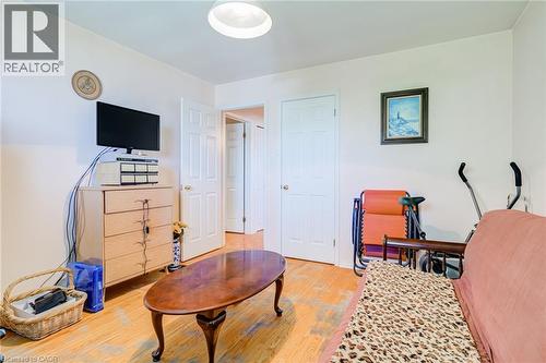 Interior room featuring wood-finish flooring, white walls, and a flush-mount ceiling light - 186 Adeline Avenue, Hamilton, ON - Indoor