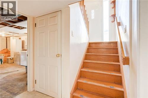 Wood-finish staircase with coordinating handrail - 186 Adeline Avenue, Hamilton, ON - Indoor Photo Showing Other Room