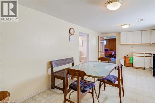 Kitchen area featuring light-colored walls and patterned sheet vinyl flooring - 186 Adeline Avenue, Hamilton, ON - Indoor