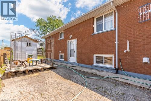 Rear exterior featuring brick siding and multiple windows - 186 Adeline Avenue, Hamilton, ON - Outdoor With Exterior