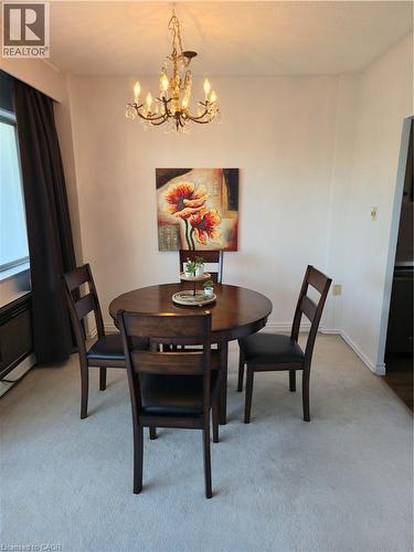 Crystal chandelier lighting fixture - 45 Westmount Road N Unit# 202, Waterloo, ON - Indoor Photo Showing Dining Room