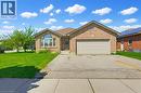 Brick and stone facade residence featuring a prominent arched window, an attached two-car garage, and a concrete driveway - 6 General Street, Brantford, ON  - Outdoor 
