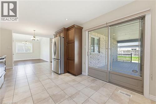 Kitchen with square tile flooring, stainless steel refrigerator, and dark wood cabinetry - 6 General Street, Brantford, ON - Indoor Photo Showing Other Room