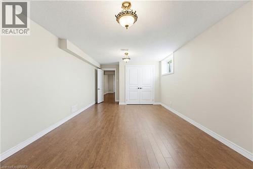 Spacious room with wood-finish flooring, white baseboards, and neutral wall tones - 6 General Street, Brantford, ON - Indoor Photo Showing Other Room