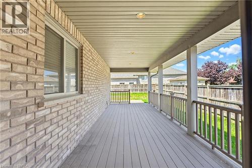 Expansive covered deck featuring composite wood-finish decking, white vinyl railings, and a recessed ceiling light - 6 General Street, Brantford, ON - Outdoor With Deck Patio Veranda With Exterior