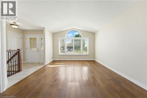 Spacious room featuring vaulted ceilings, wood-finish flooring, and neutral wall tones - 6 General Street, Brantford, ON - Indoor Photo Showing Other Room
