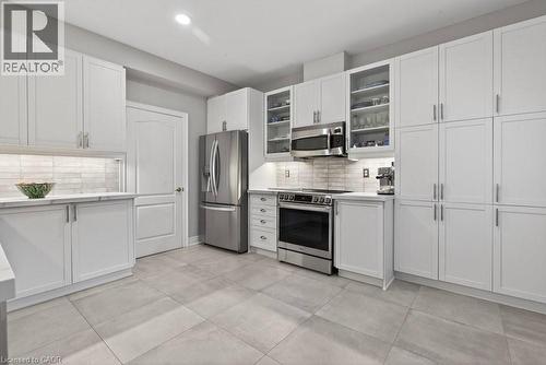 recent 16""x16"" porcelain tile floors - 100 Beddoe Drive Unit# 101, Hamilton, ON - Indoor Photo Showing Kitchen With Stainless Steel Kitchen