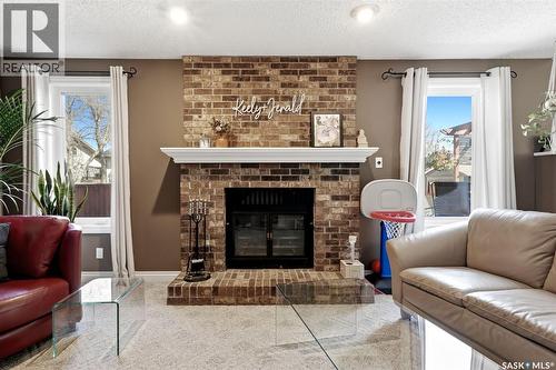 2947 More Crescent E, Regina, SK - Indoor Photo Showing Living Room With Fireplace