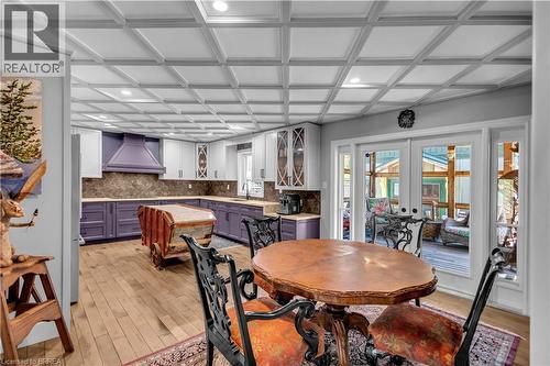 Spacious kitchen featuring a large island, wood-finish flooring, recessed lighting, and direct access to an outdoor area through sliding glass doors - 69 Hunter Way, Brantford, ON - Indoor Photo Showing Dining Room