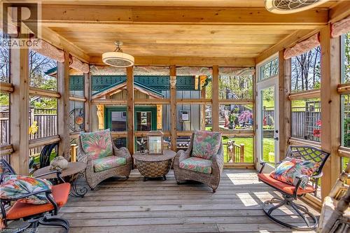 Enclosed wooden porch with a natural wood ceiling, wood-finish flooring, and exposed wood beams - 69 Hunter Way, Brantford, ON - Outdoor With Deck Patio Veranda