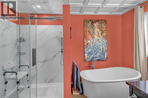 Freestanding soaking tub complemented by a separate glass-enclosed shower with white marble-look paneling - 69 Hunter Way, Brantford, ON - Indoor Photo Showing Bathroom