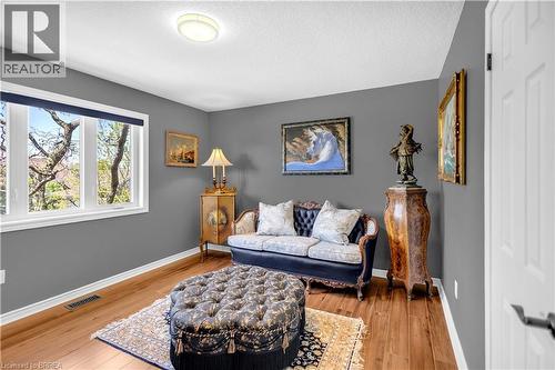 Warm wood-finish flooring complements the neutral wall color - 69 Hunter Way, Brantford, ON - Indoor Photo Showing Living Room