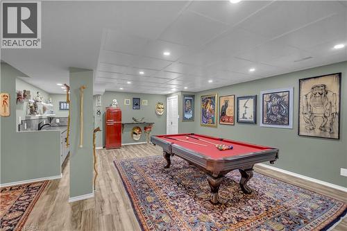 Recreation space featuring a billiard table with red felt, wood-finish flooring, recessed lighting, and a drop panel ceiling - 69 Hunter Way, Brantford, ON - Indoor Photo Showing Other Room