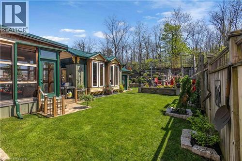 Expansive green lawn providing a contrast to the natural wood siding and green metal roofing - 69 Hunter Way, Brantford, ON - Outdoor