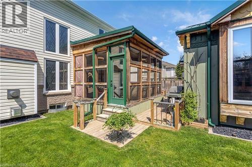 Screened-in porch with wood framing and a green door - 69 Hunter Way, Brantford, ON - Outdoor