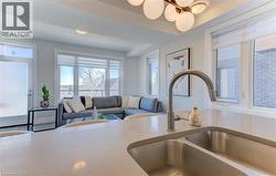 Kitchen island with an undermount double-bowl stainless steel sink and gooseneck faucet - 