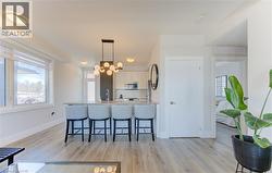 Modern kitchen island with a stone-finish countertop and contemporary pendant lighting - 