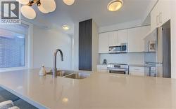 Kitchen island featuring a double basin stainless steel sink with a gooseneck faucet - 