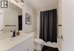 Modern bathroom featuring a single vanity with an integrated sink, a dark bronze faucet, and a wall-mounted mirror - 