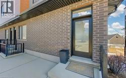 Modern brick facade featuring a full-light entry door with transom - 