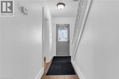 Entryway featuring a decorative transom door, wood-finish flooring, and white painted walls - 168 Britannia Avenue, Hamilton, ON - Indoor Photo Showing Other Room